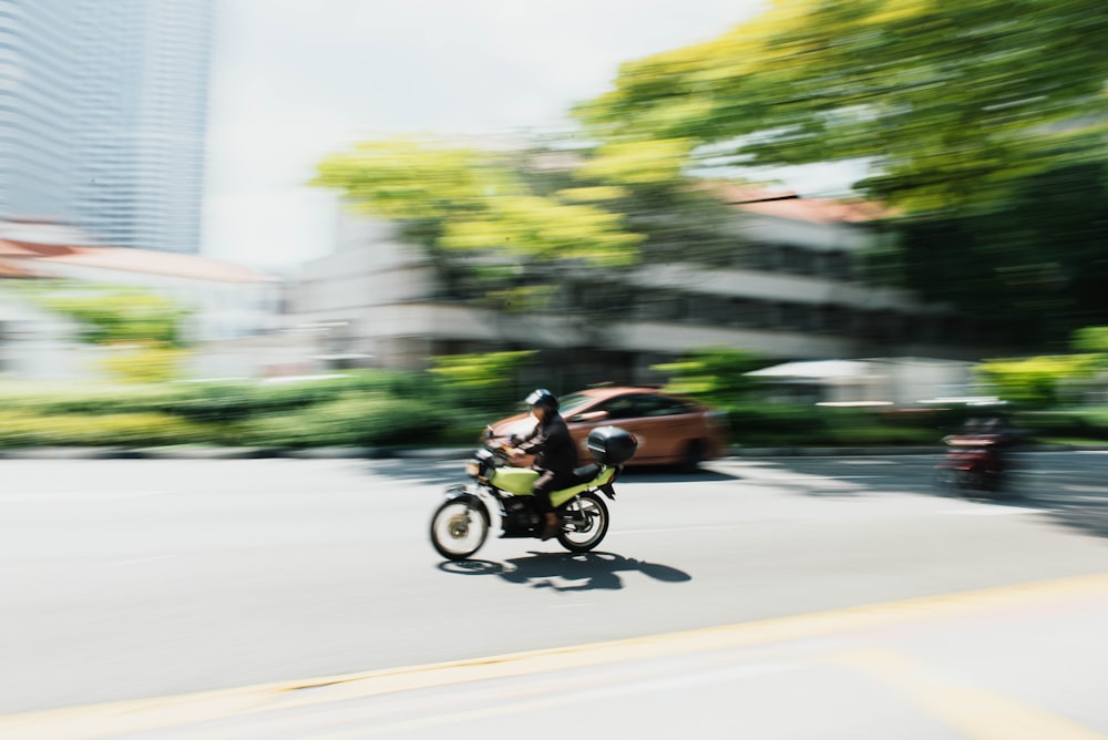 person riding motorcycle on concrete road