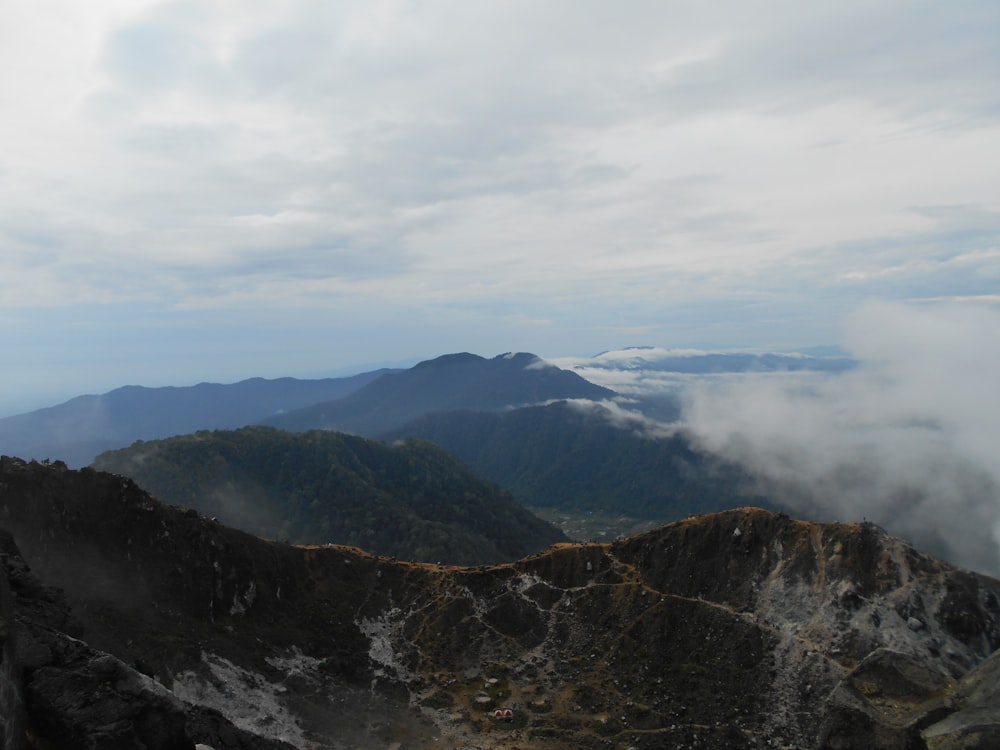 aerial photo of mountain covered by white smoke at daytime