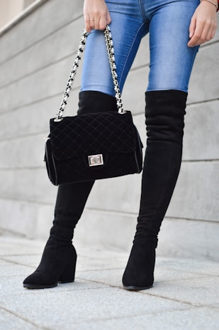 person carrying black sling bag