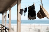 An artistic photo of a bikini drying on a clothesline with the ocean in the background.