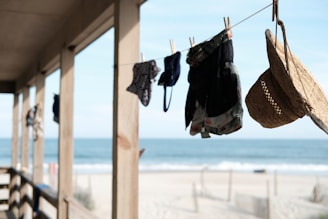 An outdoor scene featuring sun hats hanging on a clothesline.