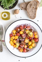 A vibrant salad with fresh greens, cherry tomatoes, and a drizzle of olive oil.