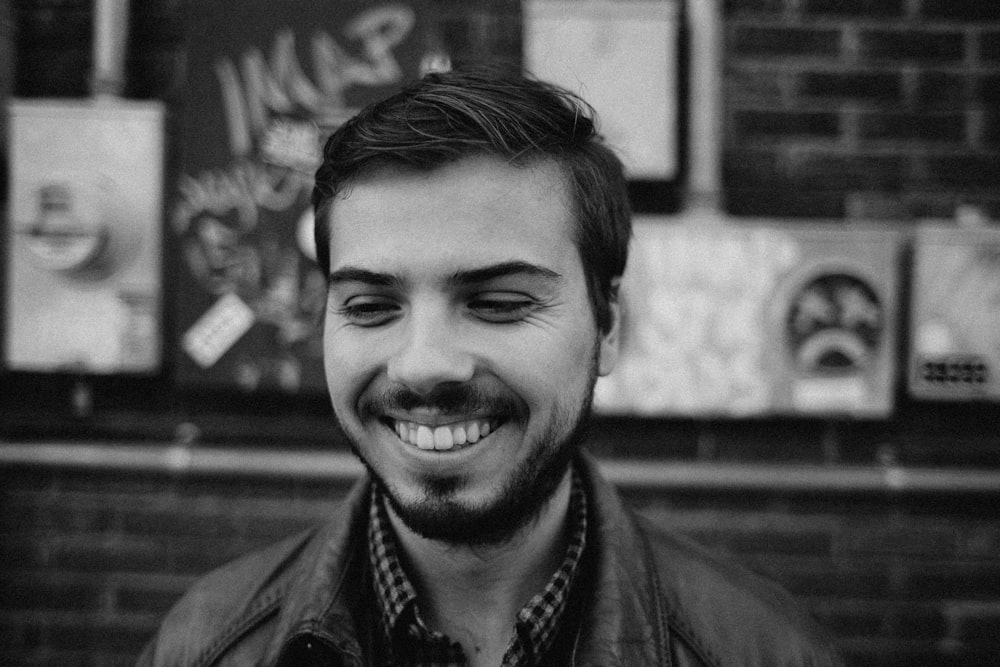 grayscale of man smiling