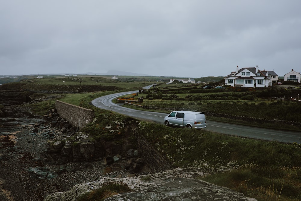 white panel van moving on grey curved road