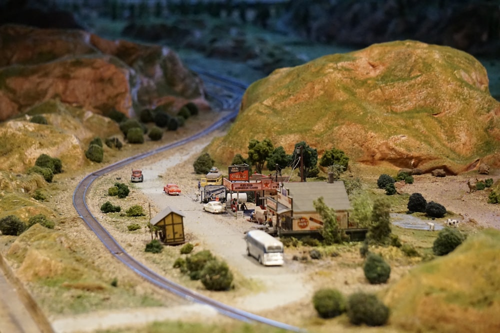 miniature town beside mountain and highway