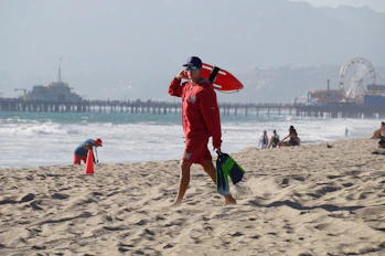 lifeguard walking in a sand shore