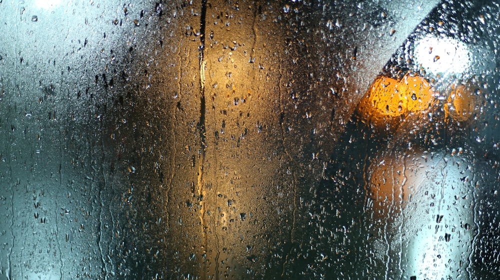 a wet window with a traffic light on it
