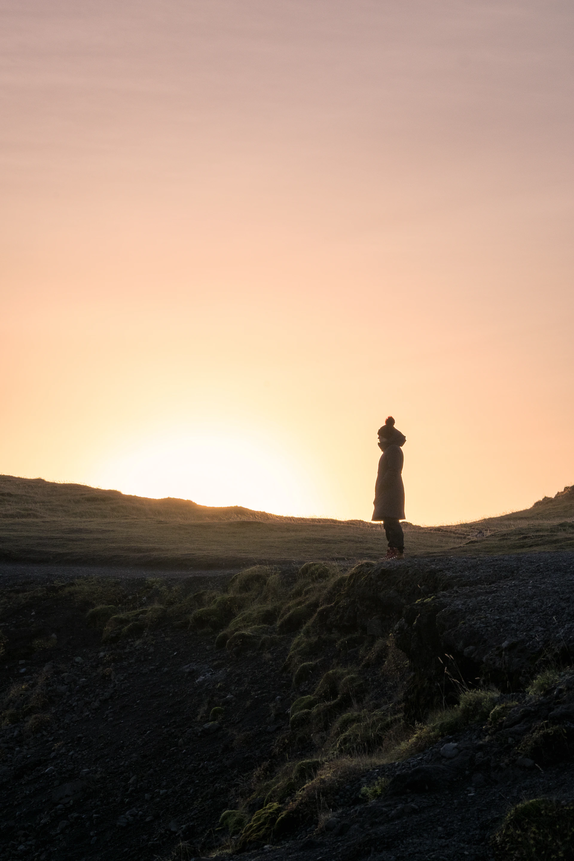 woman wearing yellow long-sleeved dress under white clouds and blue sky during daytime