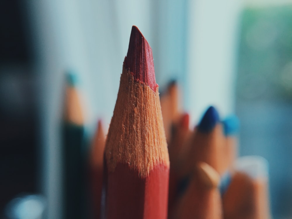 selective focus photography of red color pencil