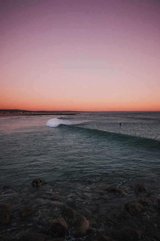 person surfing on body of water in Costa da Caparica Portugal