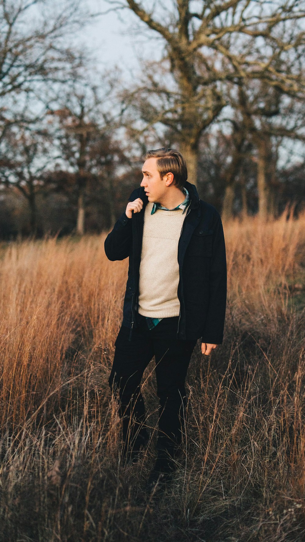 man standing on brown field