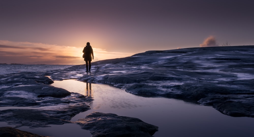 person walking near body of water