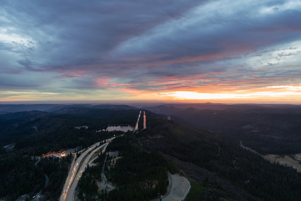 an aerial view of a road in the mountains