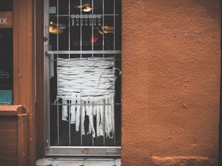 A vibrant storefront with custom black and orange vinyl decals on the windows.