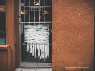 A welcoming storefront of a glass and aluminum workshop with blue and black accents.