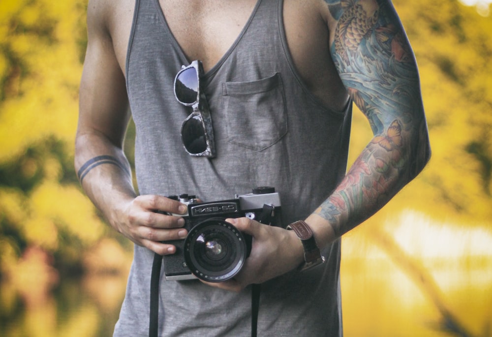 man holding DSLR camera