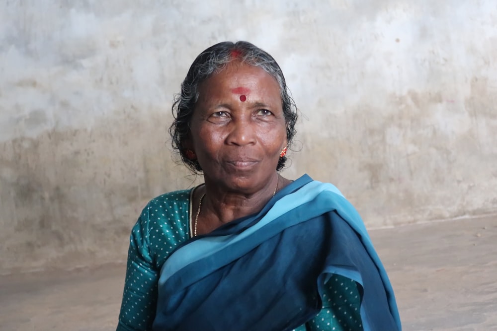 woman wearing blue and teal polka-dot sari dress