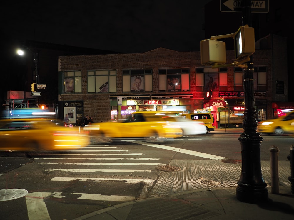 panning photo of cars on road during nighttime