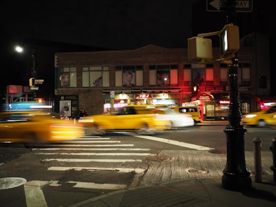 panning photo of cars on road during nighttime vanguard zoom background