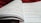 An open book with pages filled with mathematical formulas and text. The writing includes complex equations and mathematical symbols spread across two facing pages. The background is soft and out of focus, with what appears to be a red fabric.