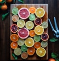 assorted sliced citrus fruits on brown wooden chopping board