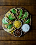 assorted tacos on wooden plate