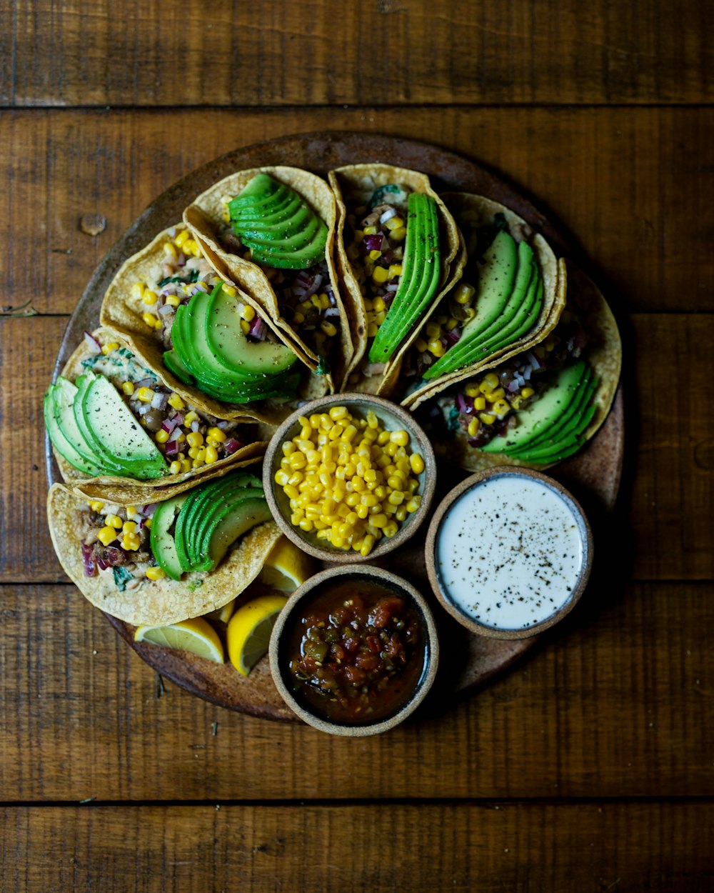 Tacos variados en plato de madera