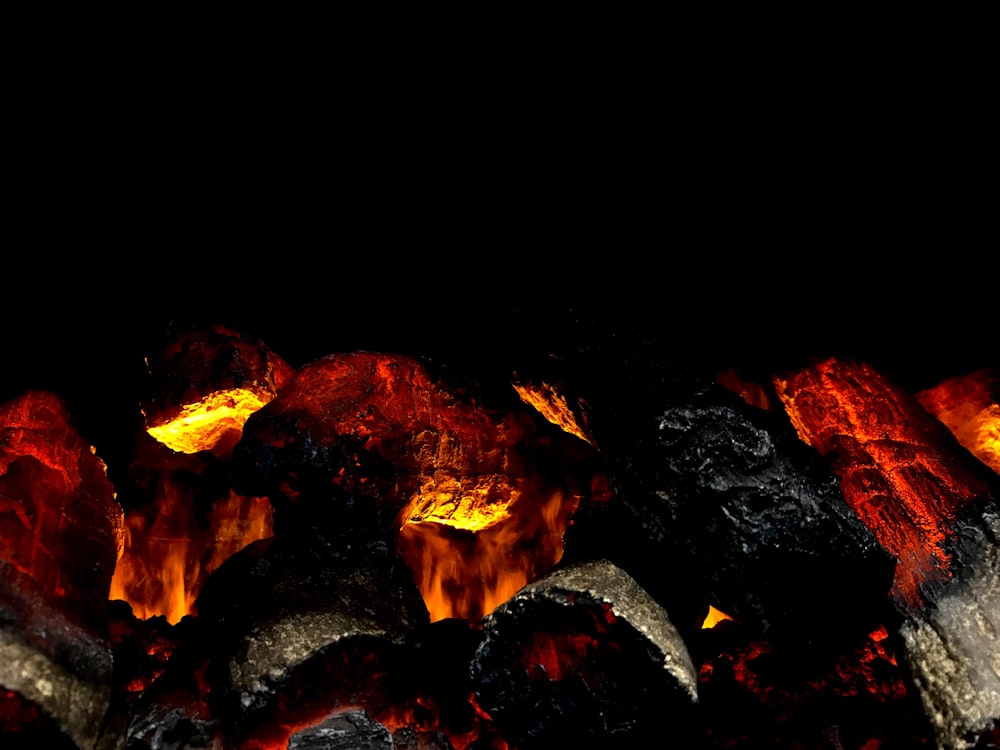 a close up of a grill with hot coals