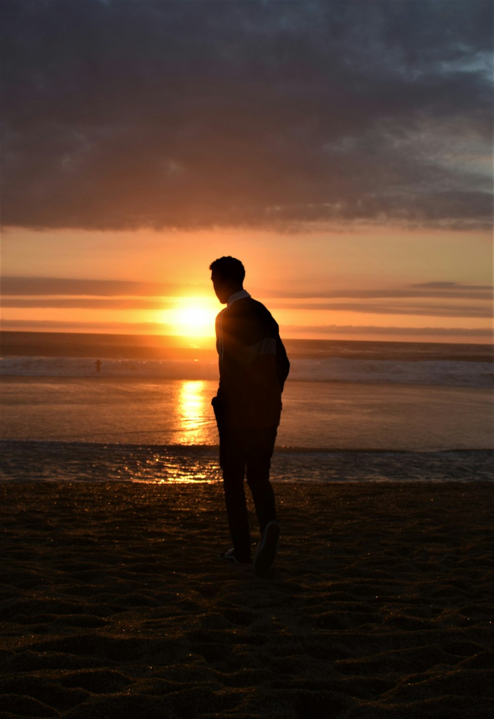 man walking seashore