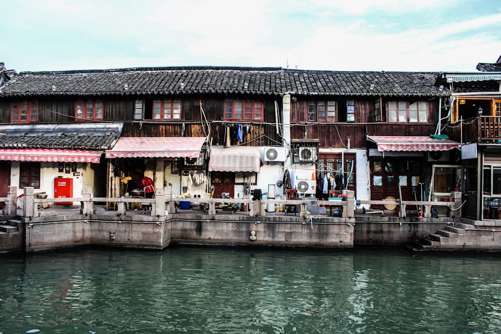 brown and pink building beside dock