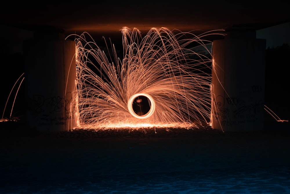 steel wool photography of person under arch