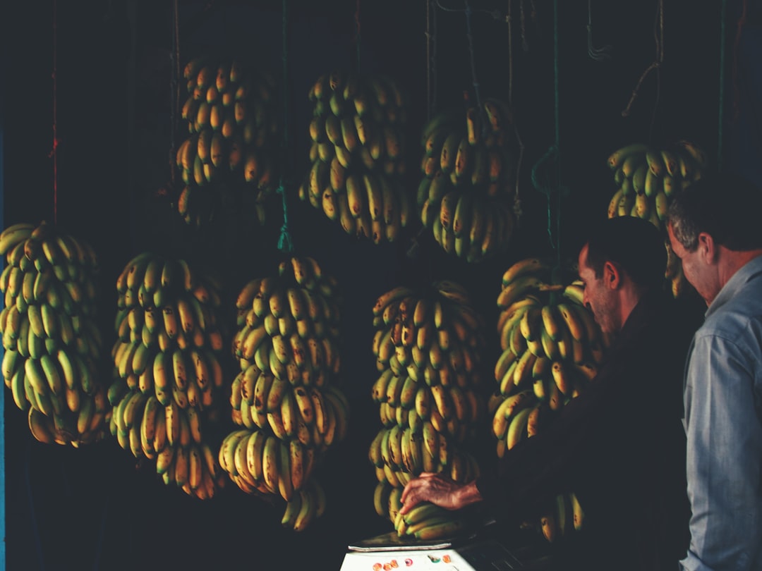 man putting banana on scale