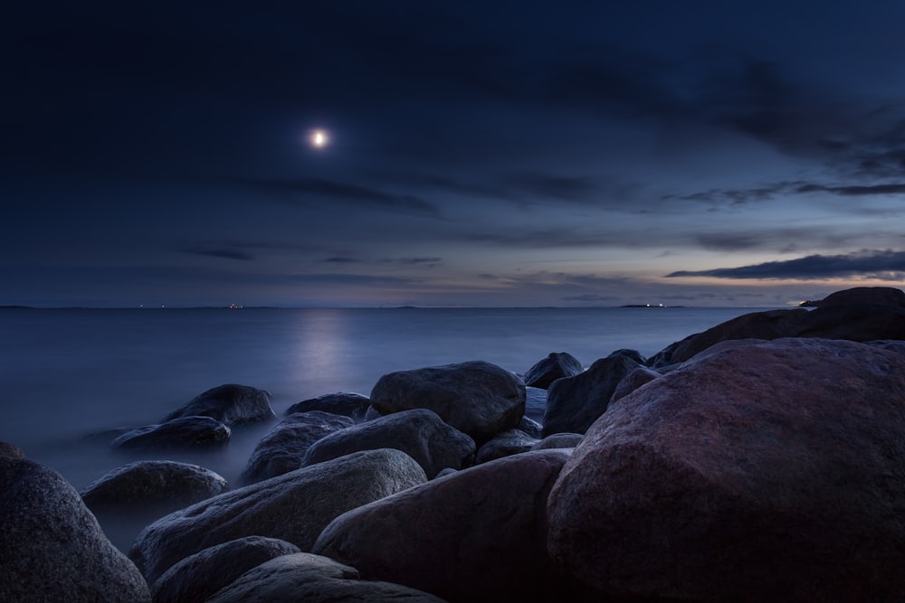 rocks near shore during nighttime