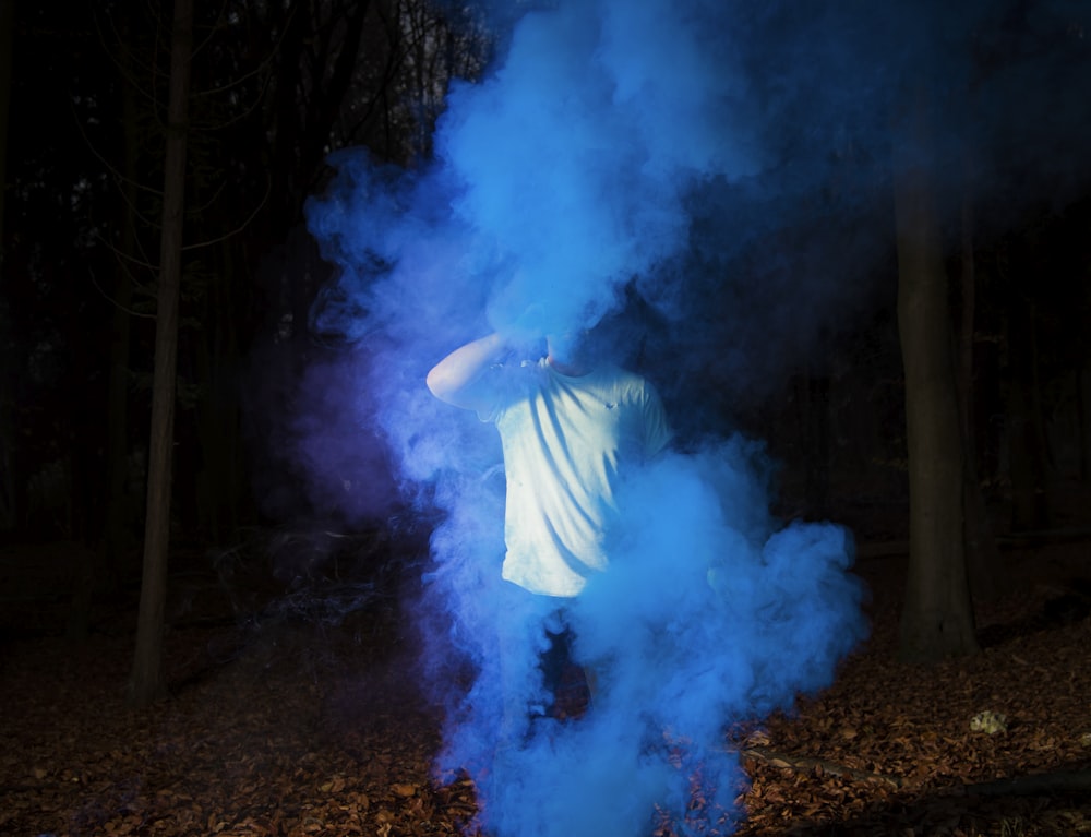 person wearing white shirt and surrounded by smoke