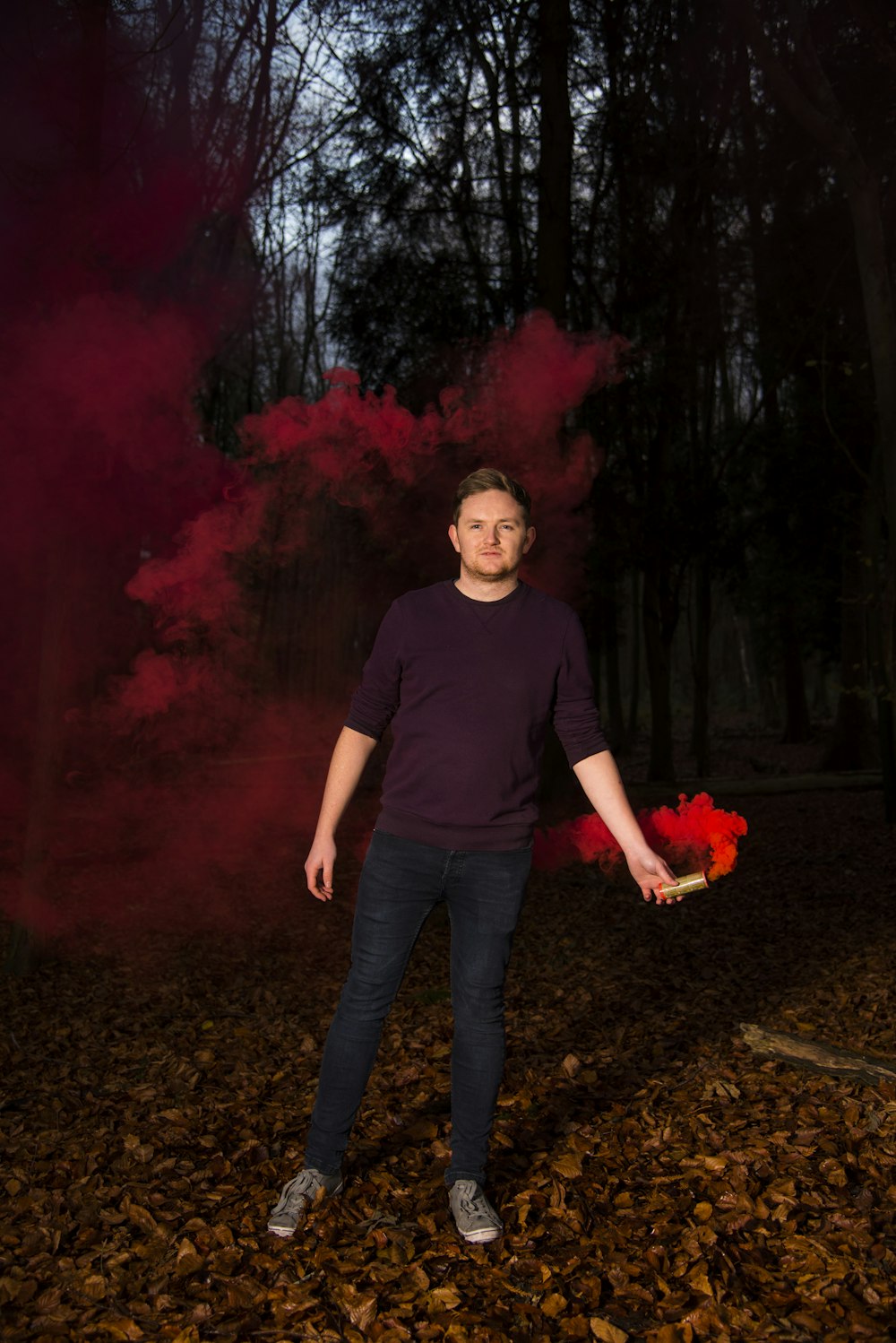 man holding red smoke