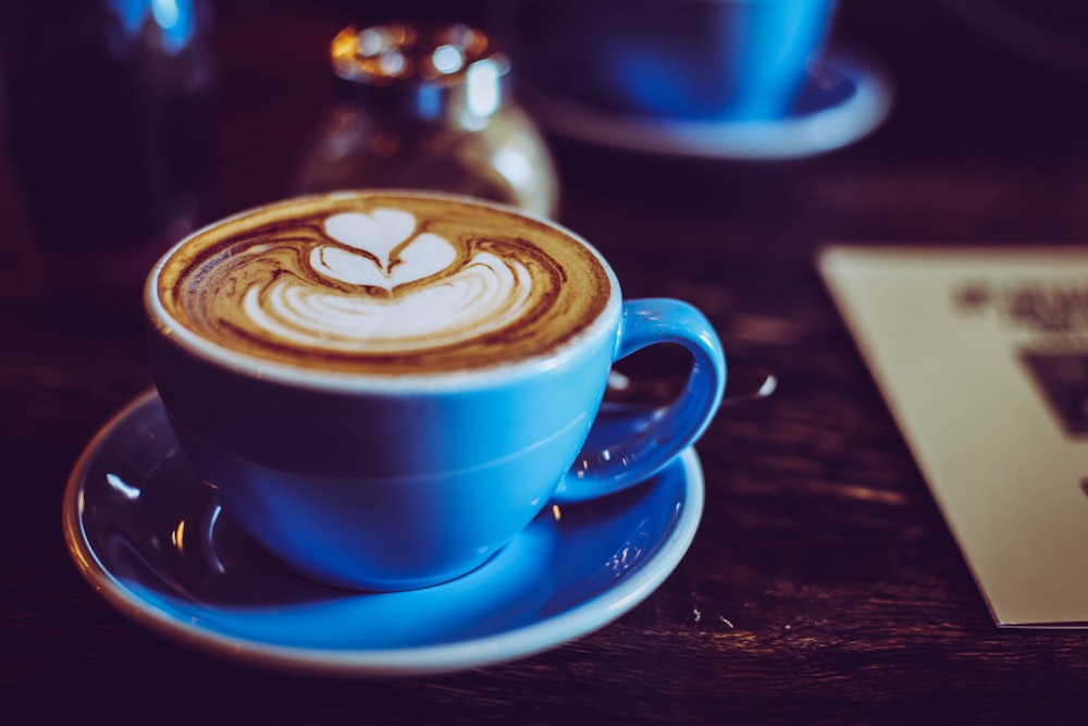 photo of blue ceramic teacup and saucer