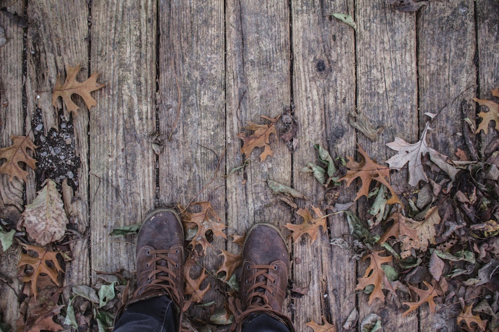 person wearing pair of brown leather shoes