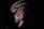 A dark, ominous figure with a textured, menacing face is partially illuminated. Wire or metal is wrapped around its head, giving a sinister appearance. The background is mostly obscured in shadow, enhancing the eerie effect.