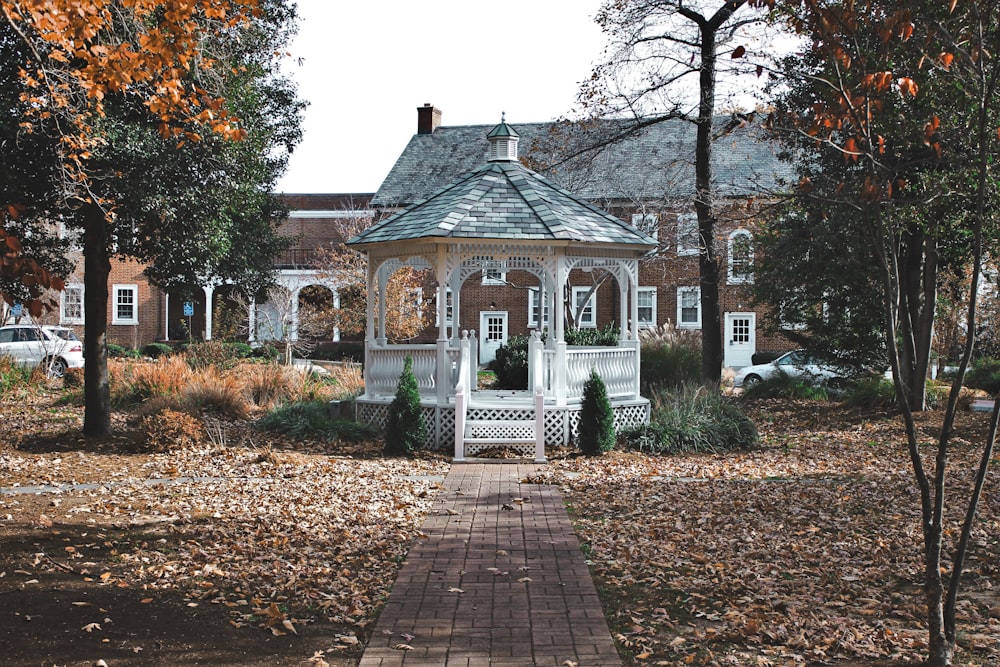 white gazebo in the middle of park during daytime