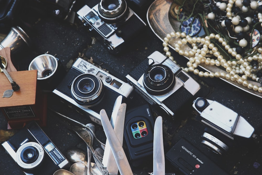 assorted cameras and jewelries