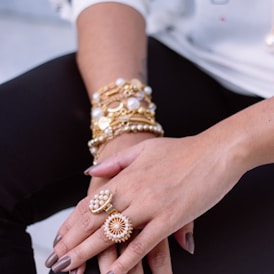 two white pearl encrusted gold-colored rings