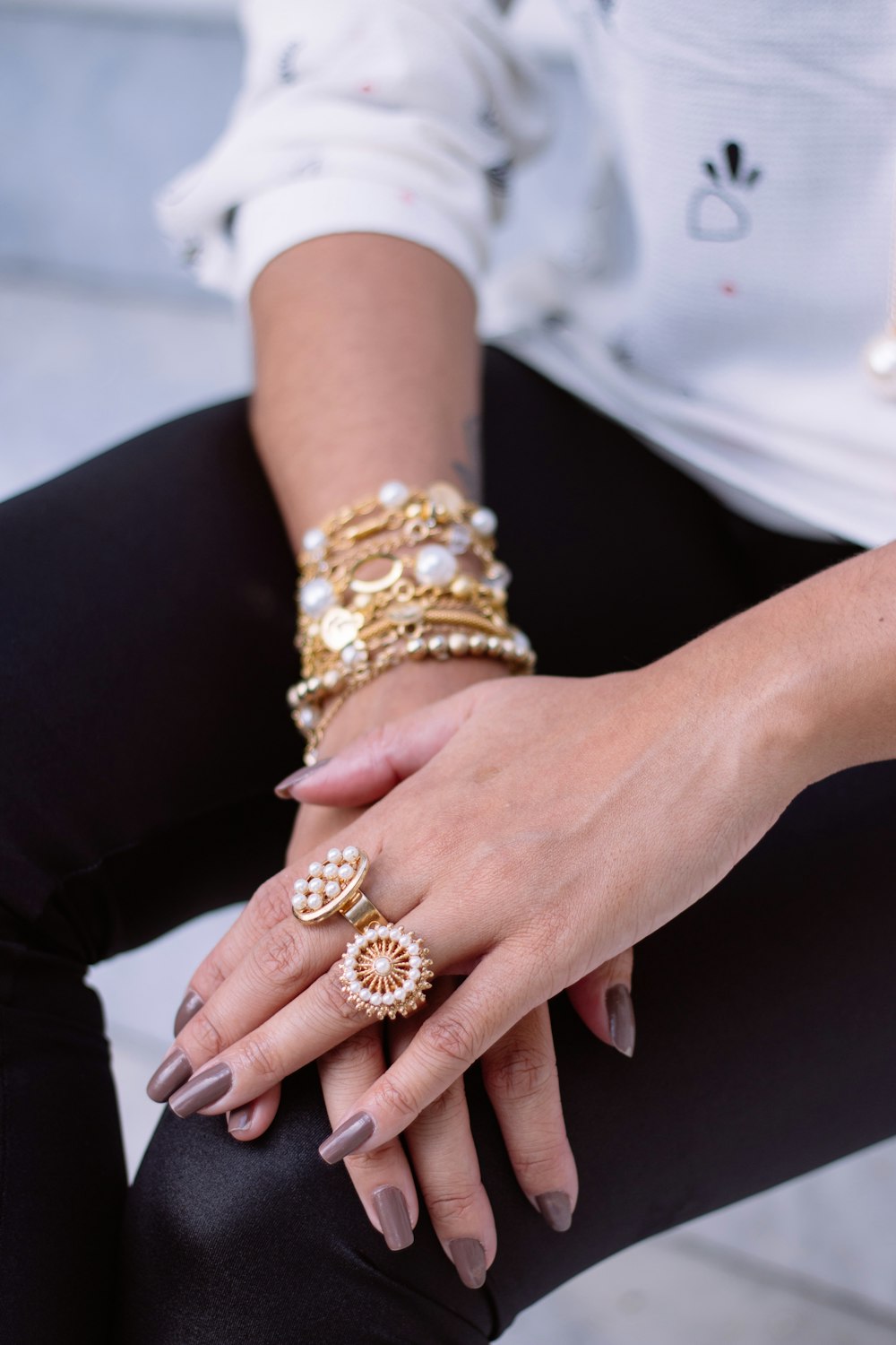 two white pearl encrusted gold-colored rings