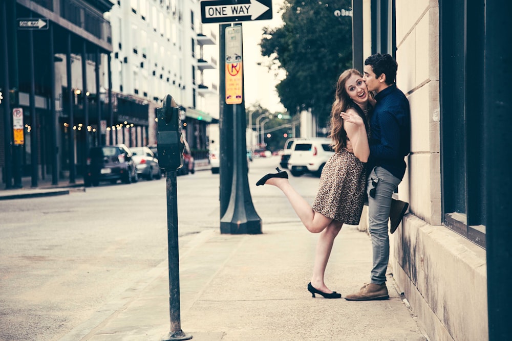 man kissing woman on street