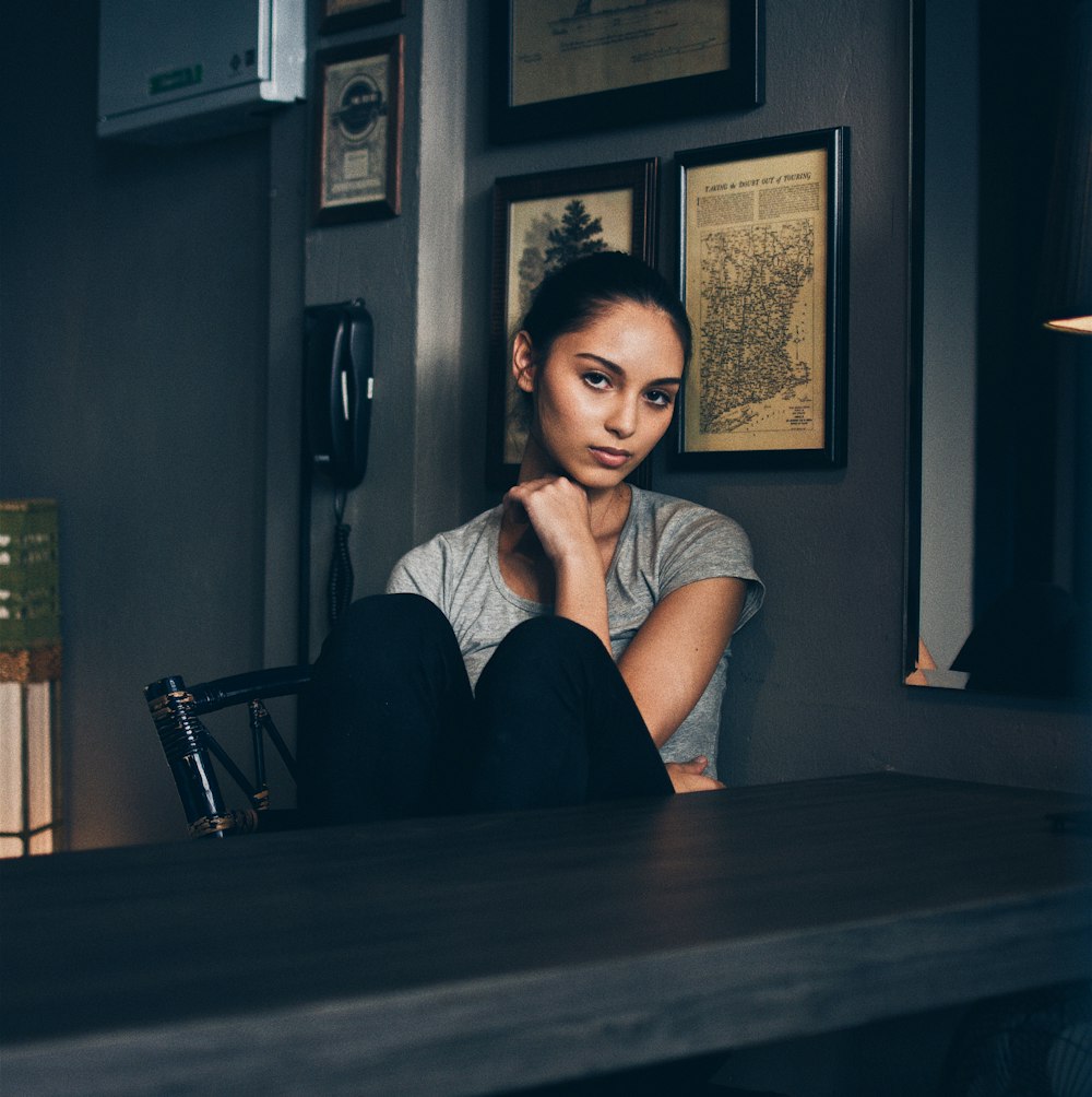 woman sitting on chair infront of empty table