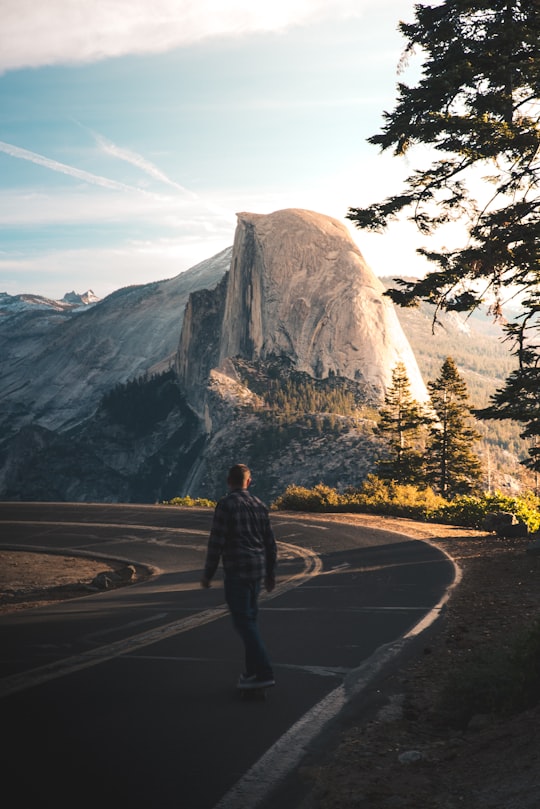 man playing skateboard on road in Yosemite National Park United States