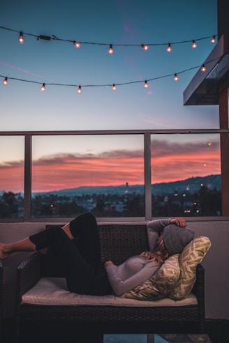 woman lying on sofa in rooftop
