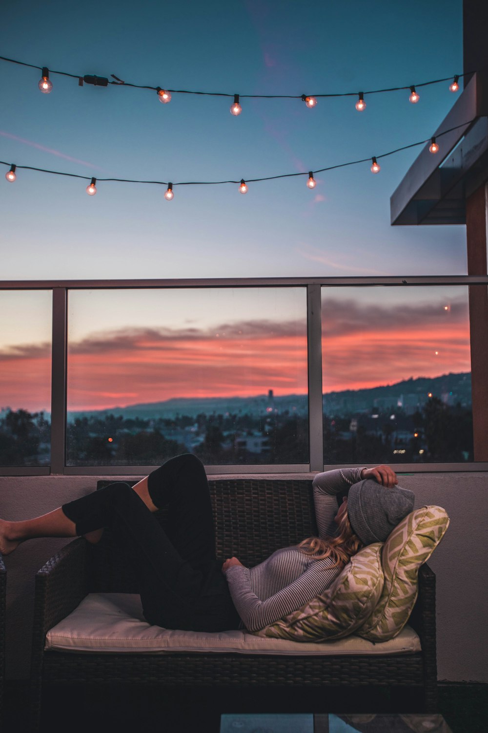 woman lying on sofa in rooftop