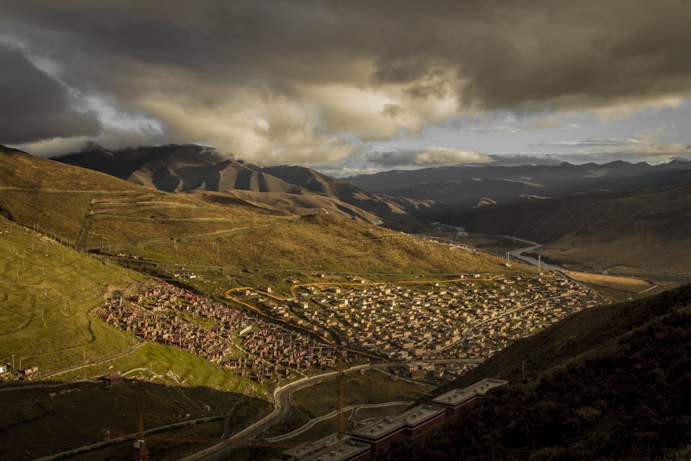 aerial photography of town on mountain foot during daytime