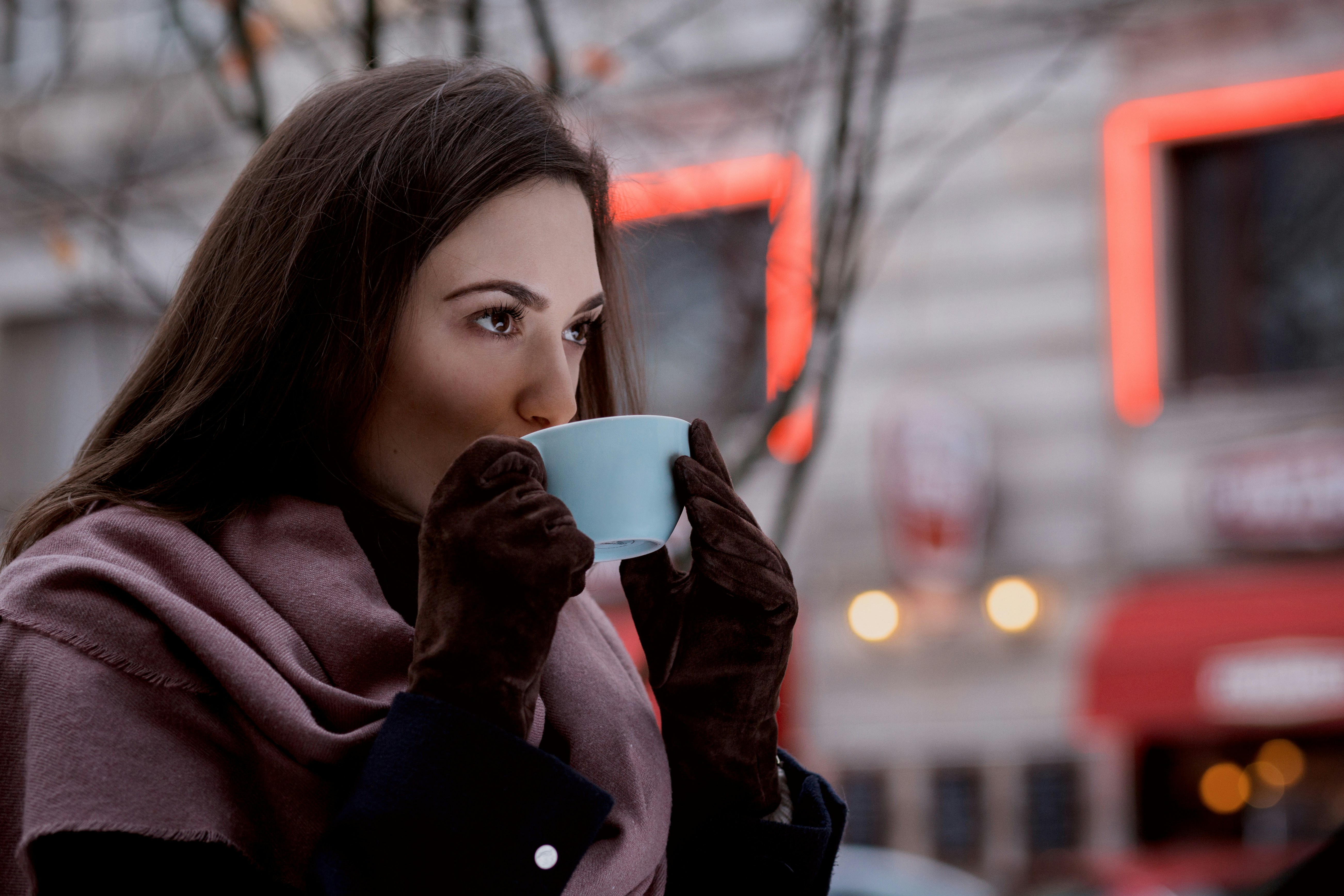 Woman enjoying coffee while managing investments