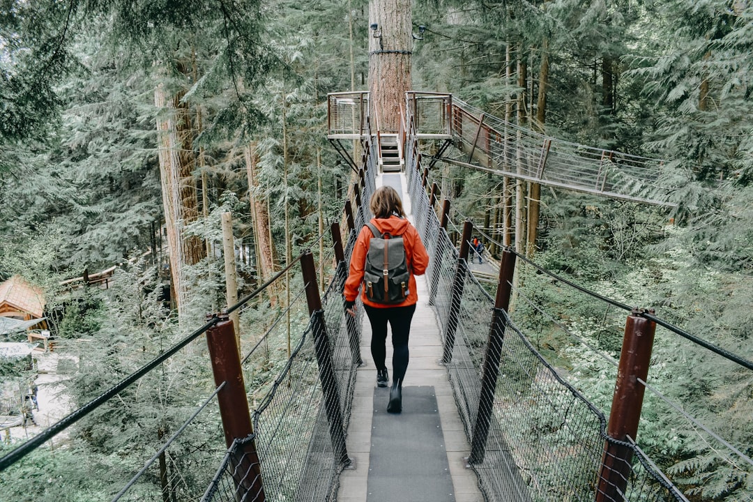 woman walking on black bridge